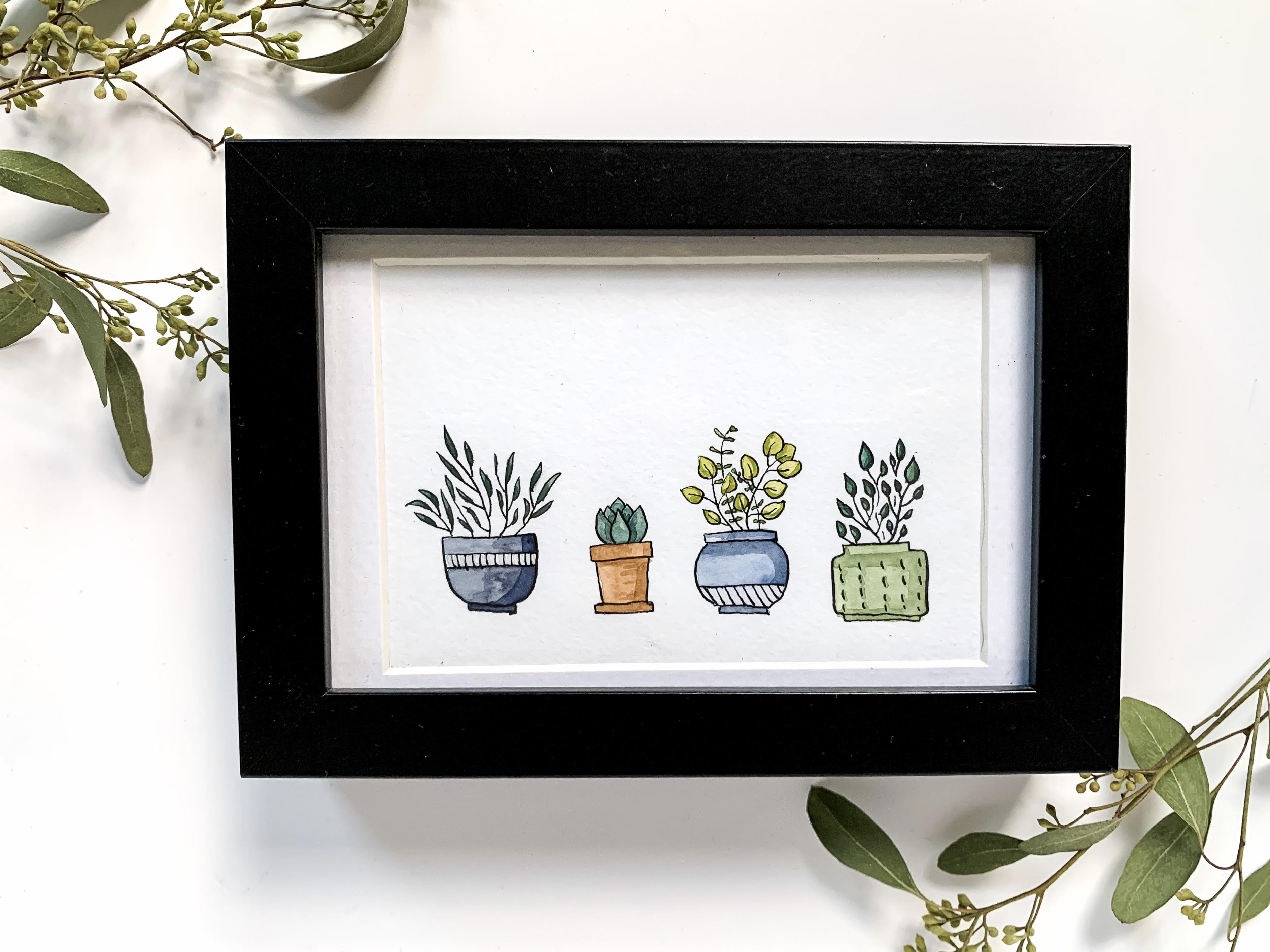 Framed painting of little watercolor flowers